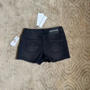 Calvin Klein Black Jean shorts mid-rise raw edge. Girl’s children size 12